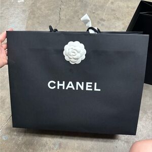 Authentic Chanel paper bag, with ribbon and camellia